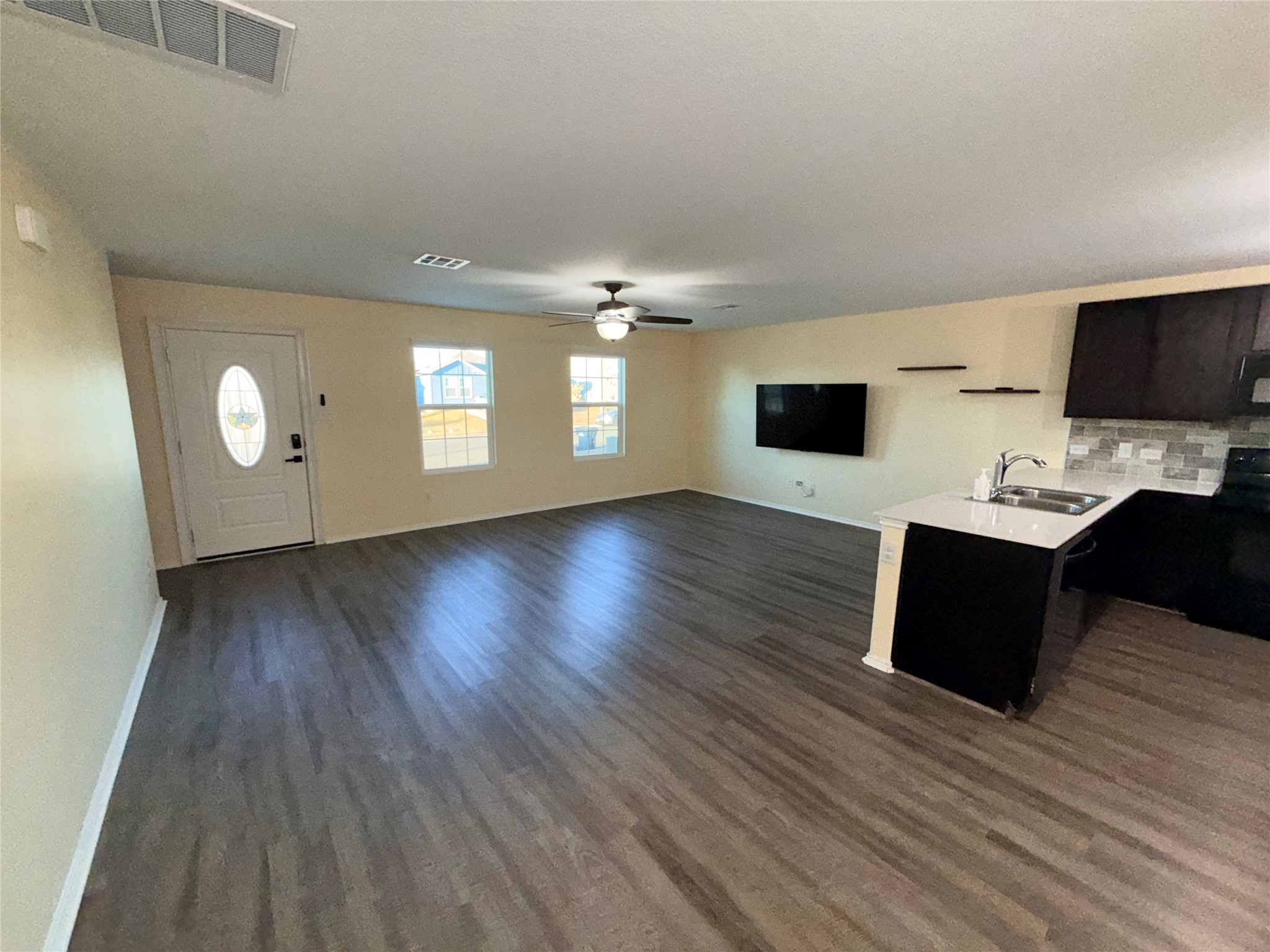 228 Texas Angel Way Jarrell, TX 76537 - Photo 33 of 33 a view of a livingroom with wooden floor and kitchen
