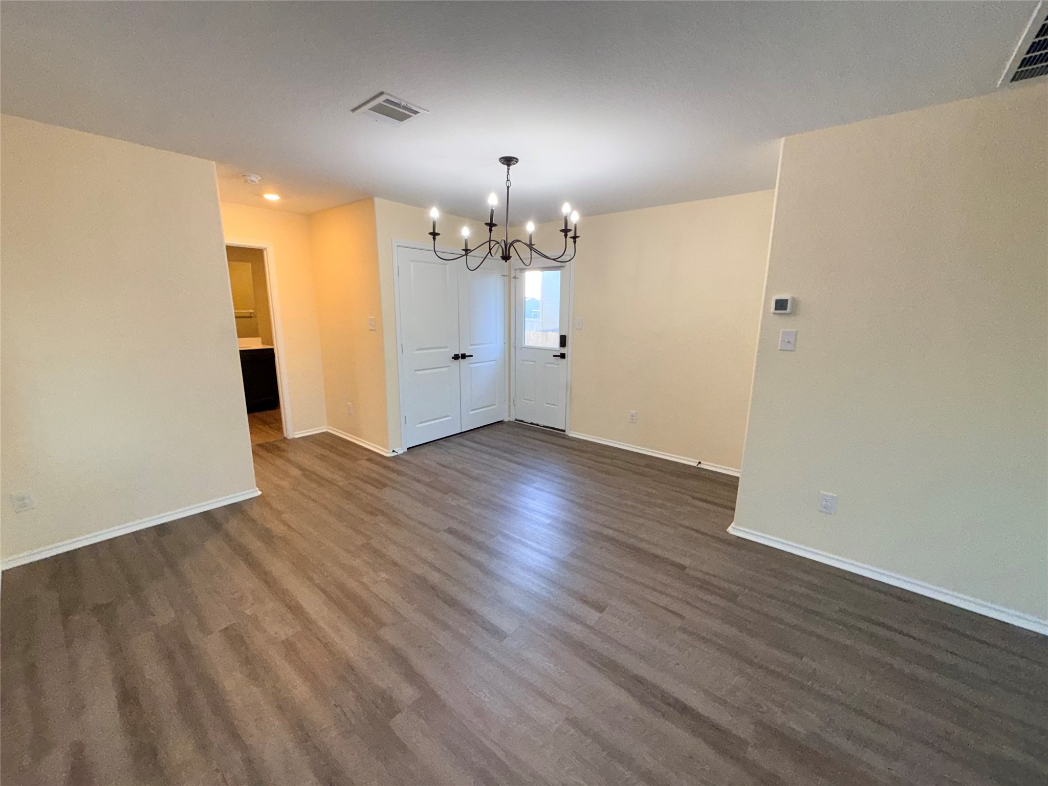 228 Texas Angel Way Jarrell, TX 76537 - Photo 7 of 33 wooden floor in an empty room with a window