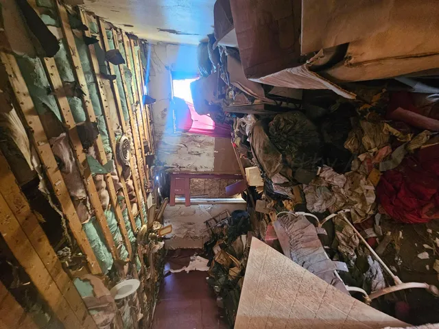 a view of a yard with wooden fence