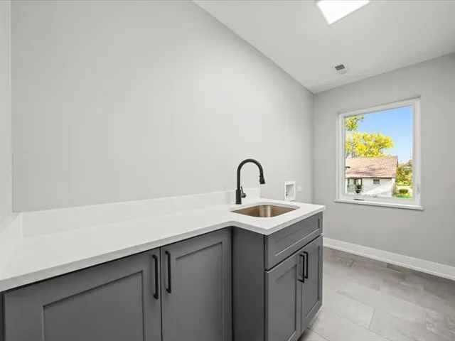 a kitchen with a sink and a window