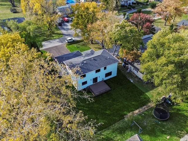 an aerial view of a house with yard swimming pool and outdoor seating