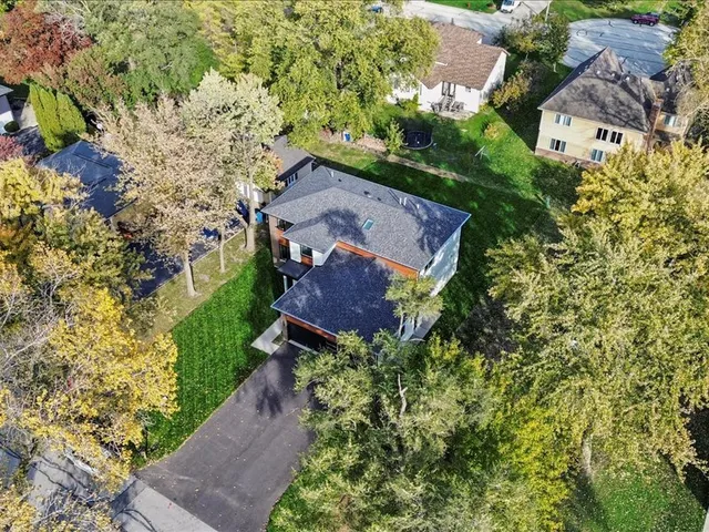 an aerial view of a house with a yard