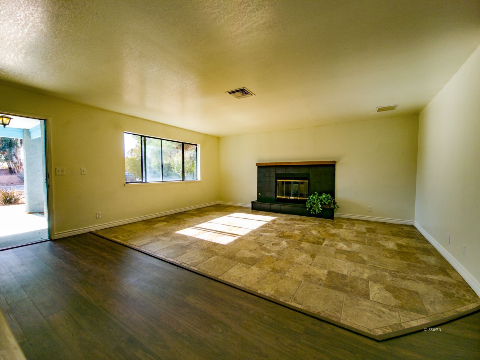 544 Weiman Avenue Ridgecrest, CA 93555 - Photo 3 of 20 a view of empty room with wooden floor and fireplace