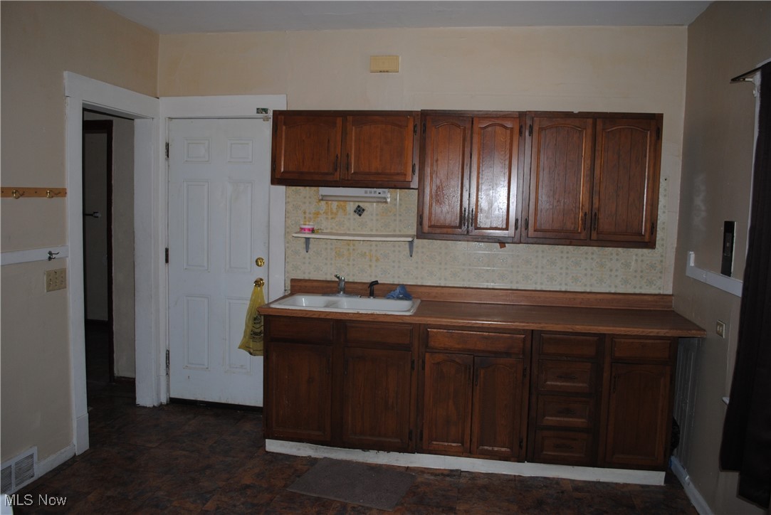 841 Whitcomb Road Cleveland, OH 44110 - Photo 18 of 30 Kitchen featuring a sink and baseboards