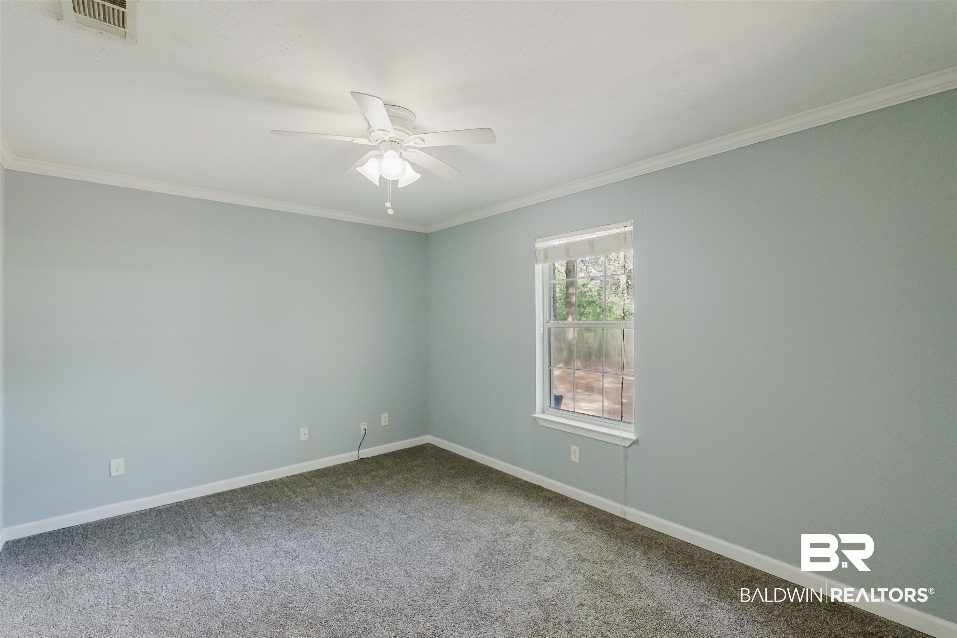 14185 Jackson Lane Foley, AL 36535 - Photo 6 of 16 Carpeted empty room featuring ornamental molding and a ceiling fan