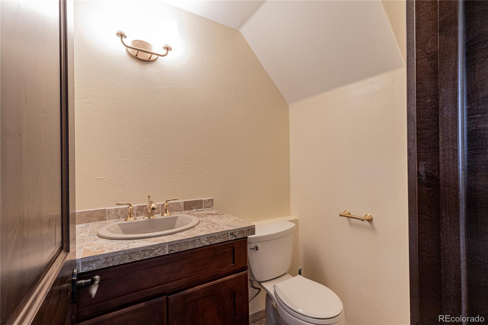26050 Henderson Park Road Oak Creek, CO 80467 - Photo 16 of 40 a bathroom with a sink toilet and a mirror