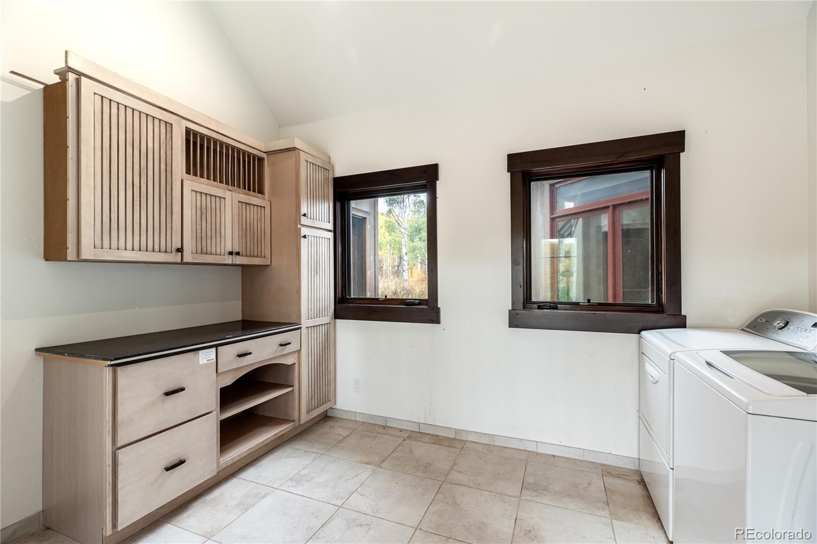26050 Henderson Park Road Oak Creek, CO 80467 - Photo 17 of 40 a kitchen with a stove and white cabinets