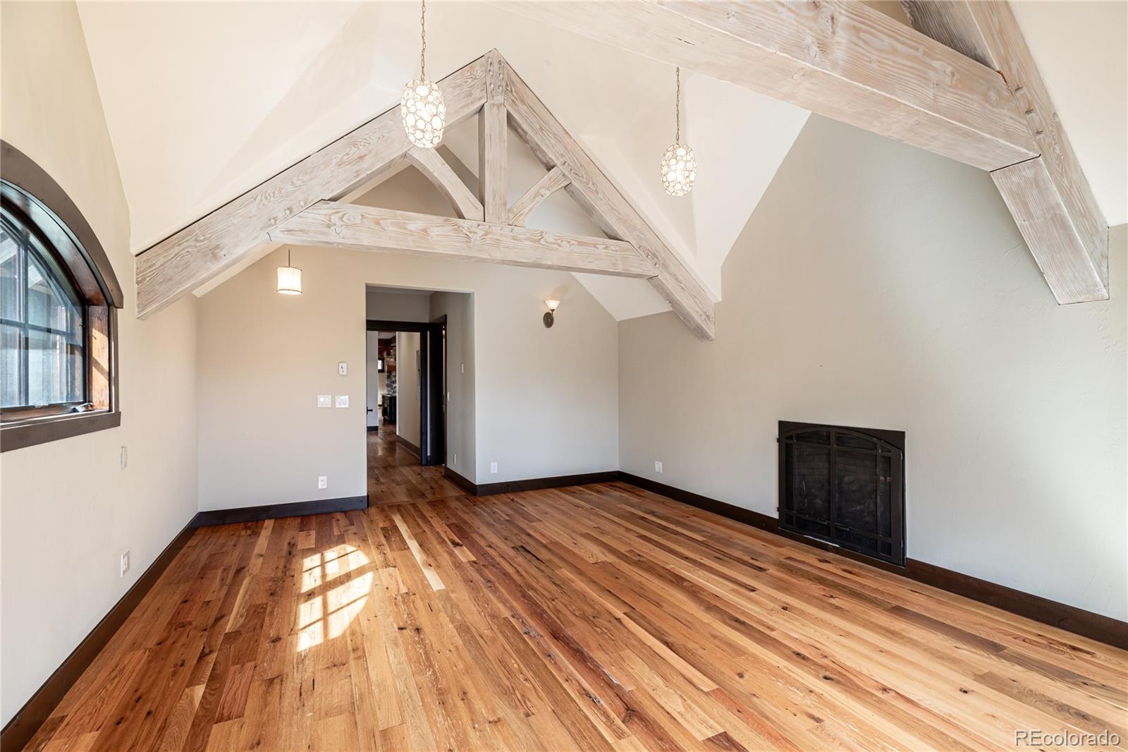 26050 Henderson Park Road Oak Creek, CO 80467 - Photo 21 of 40 a view of an empty room with wooden floor and a window