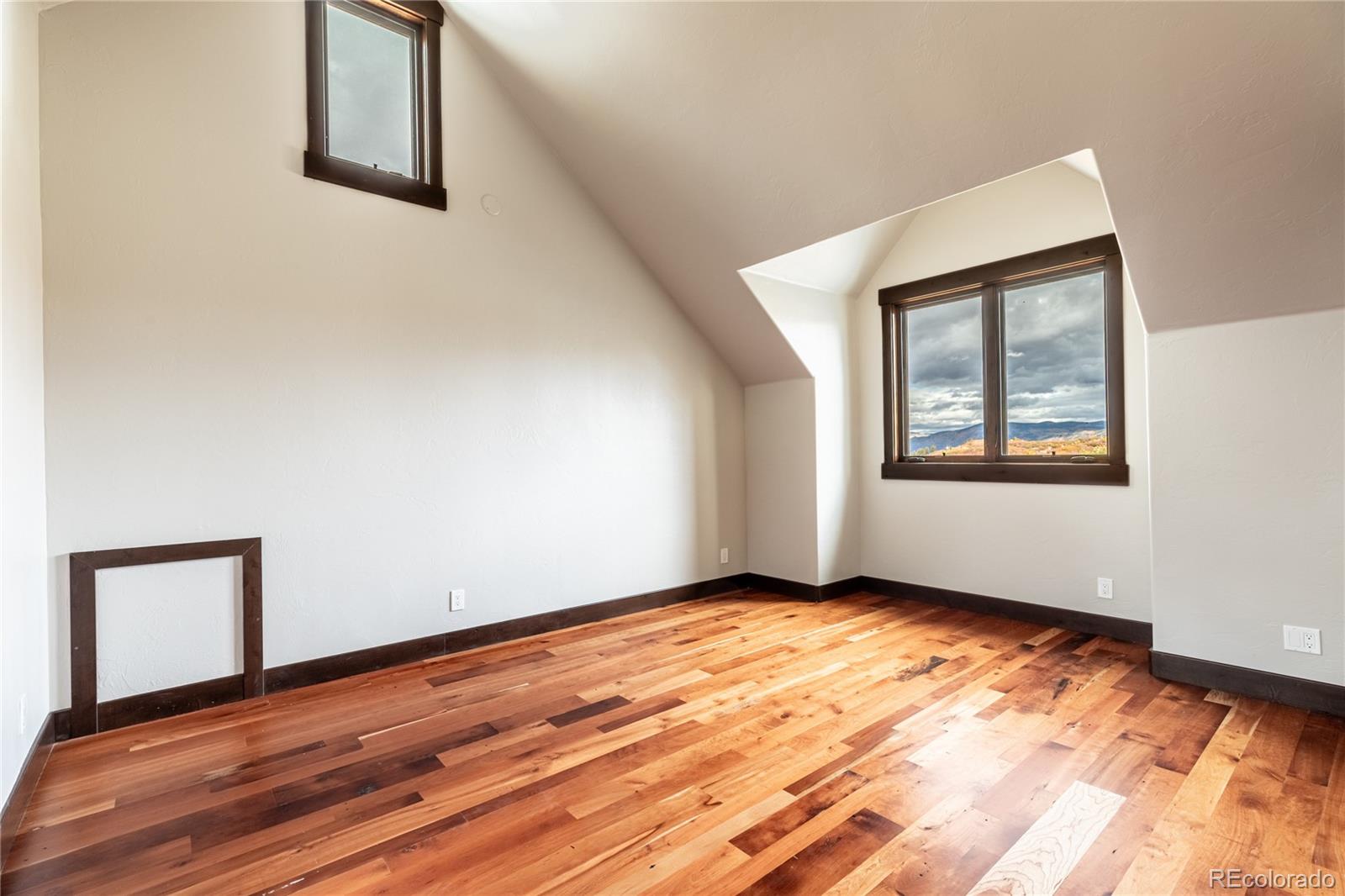 26050 Henderson Park Road Oak Creek, CO 80467 - Photo 23 of 40 a view of an empty room with wooden floor and a window