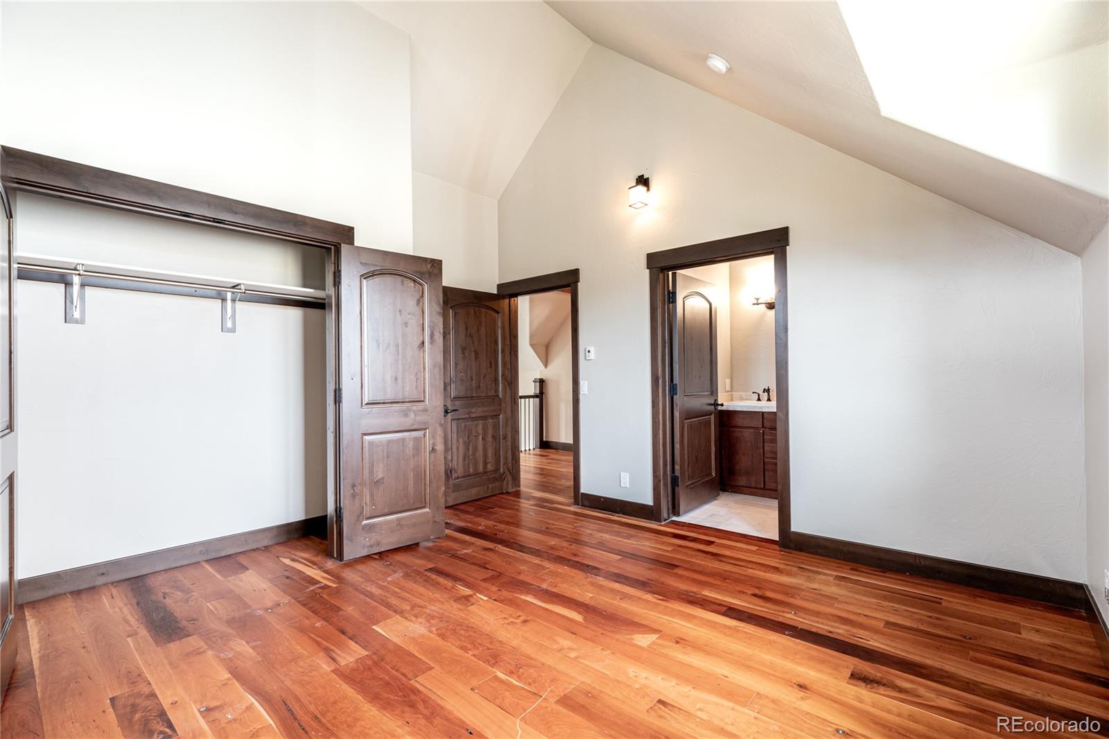 26050 Henderson Park Road Oak Creek, CO 80467 - Photo 27 of 40 an empty room with wooden floor and windows