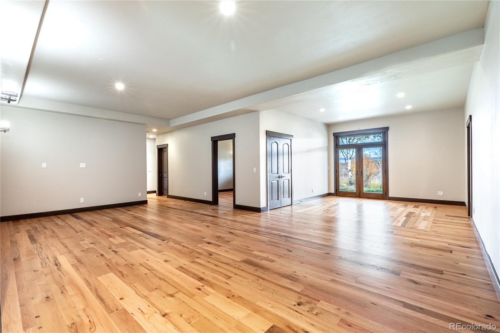 26050 Henderson Park Road Oak Creek, CO 80467 - Photo 29 of 40 a view of an empty room with window and wooden floor