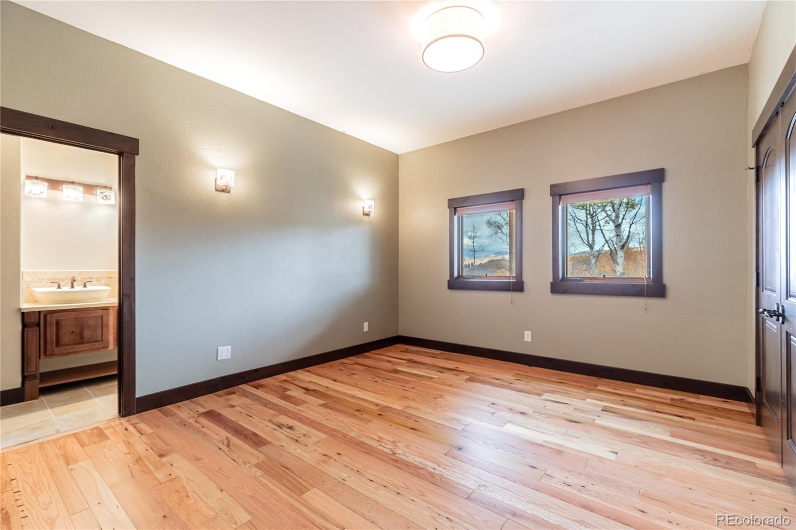 26050 Henderson Park Road Oak Creek, CO 80467 - Photo 31 of 40 a view of an empty room with a window and wooden floor