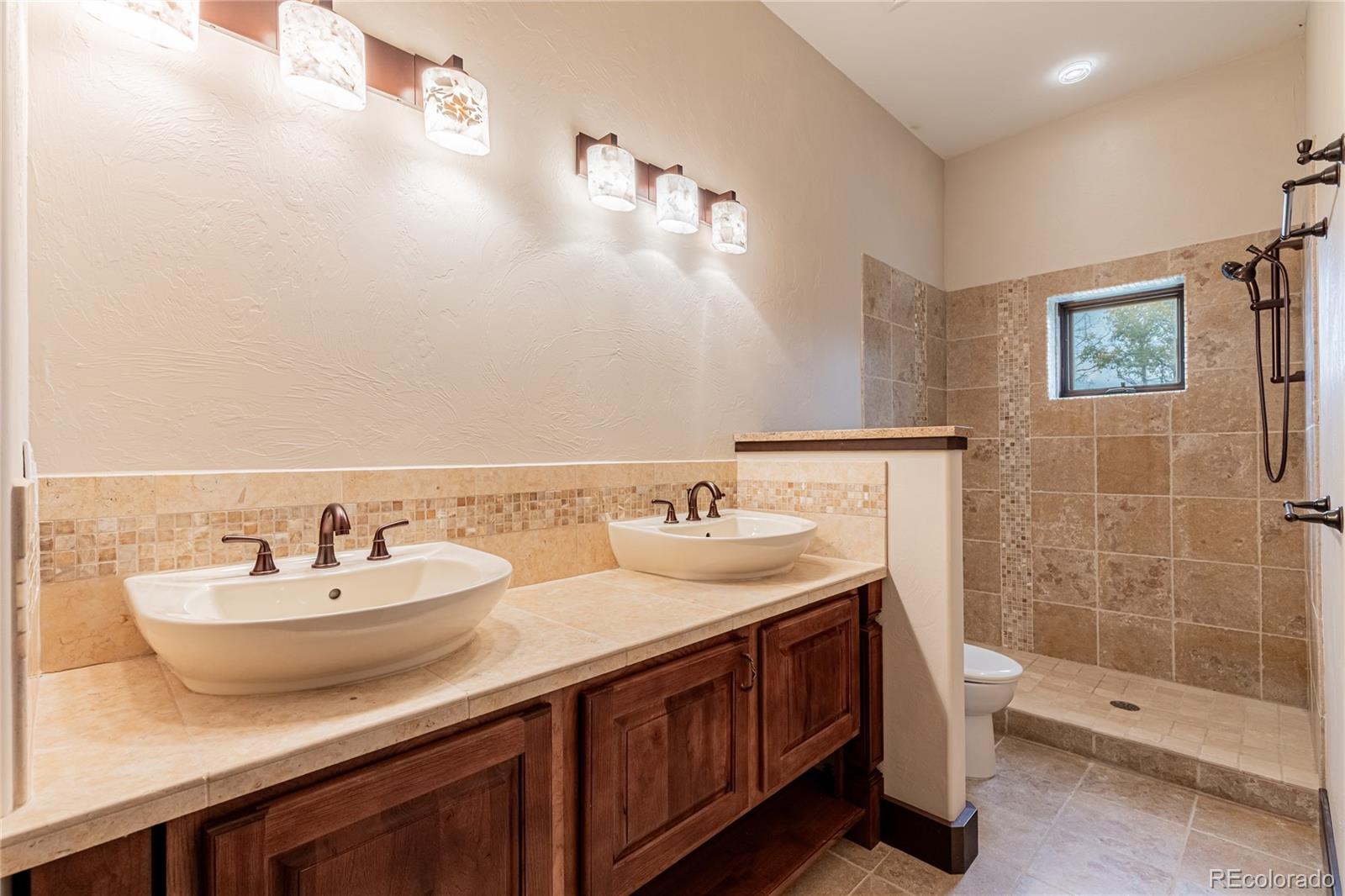 26050 Henderson Park Road Oak Creek, CO 80467 - Photo 32 of 40 a bathroom with double sink and a mirror