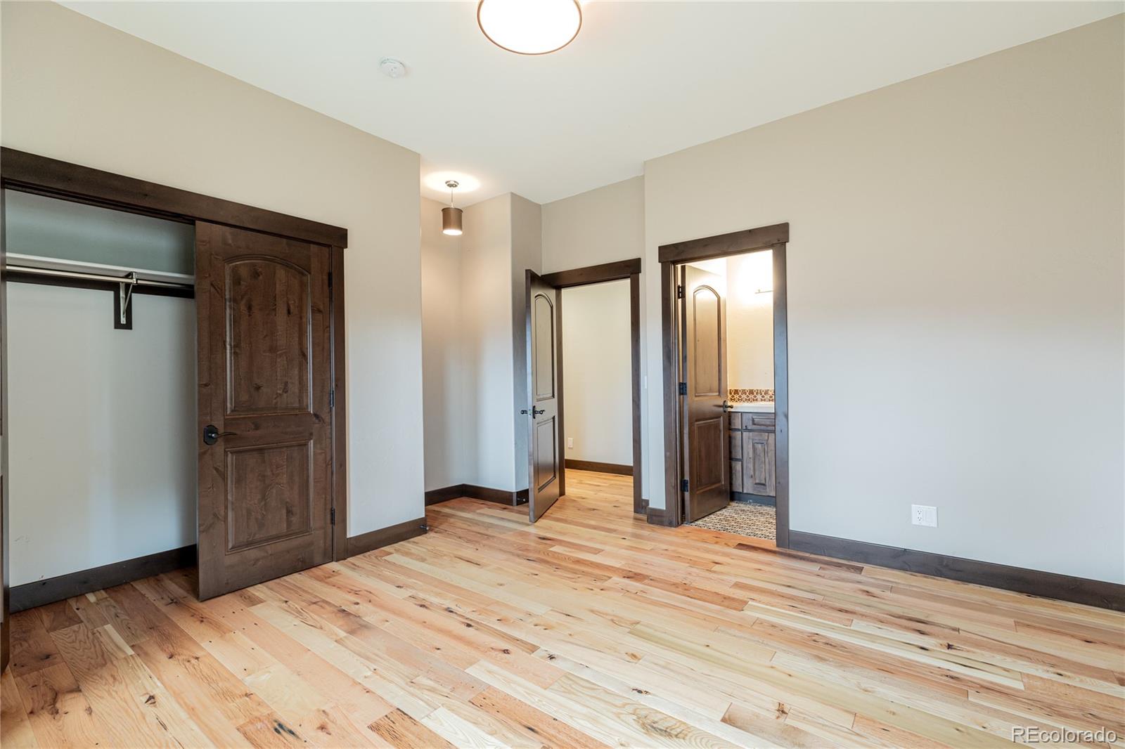 26050 Henderson Park Road Oak Creek, CO 80467 - Photo 34 of 40 a view of a room with wooden floor and closet