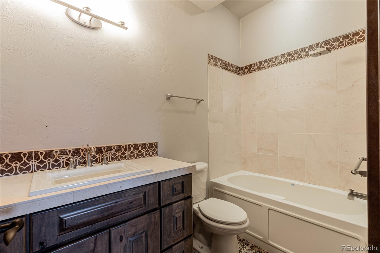26050 Henderson Park Road Oak Creek, CO 80467 - Photo 35 of 40 a bathroom with a sink a toilet and shower