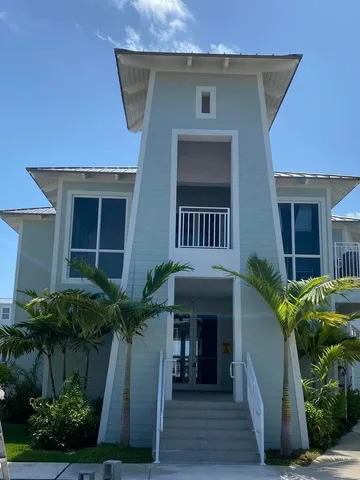 a view of a balcony with wooden floor and fence