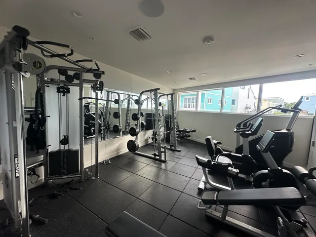 a backyard of a house with barbeque oven table and chairs