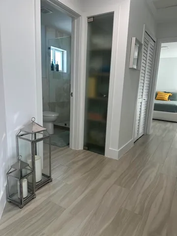 a bathroom with a toilet a sink and a mirror