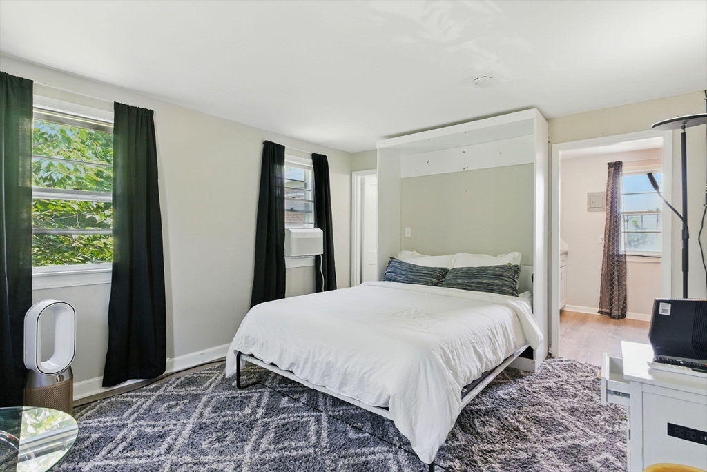 42 Newman Road, Unit 3 Malden, MA 02148 - Photo 1 of 22 a bedroom with a bed and wooden floor