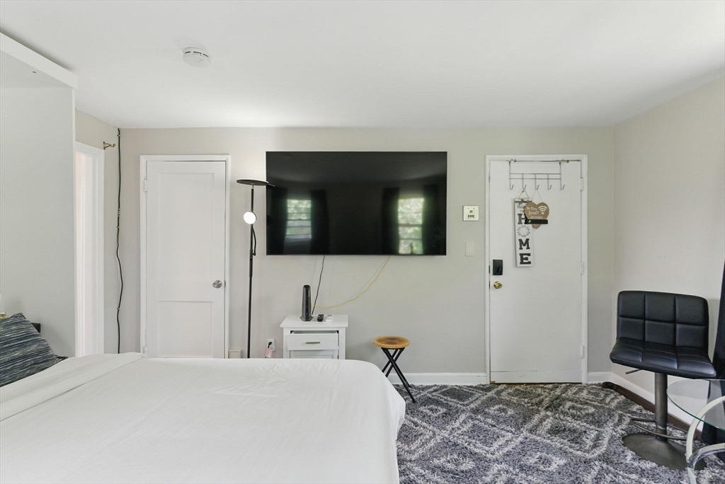 42 Newman Road, Unit 3 Malden, MA 02148 - Photo 4 of 22 a bedroom with a bed and a television