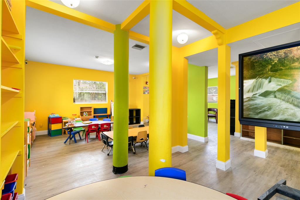 4607 North Pine Hills Road Orlando, FL 32808 - Photo 11 of 26 a living room with furniture floor to ceiling window and wooden floor