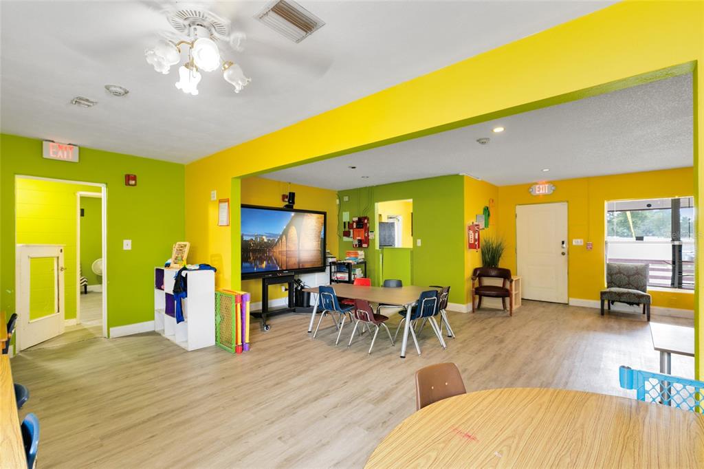 4607 North Pine Hills Road Orlando, FL 32808 - Photo 13 of 26 a living room with furniture dining table and a large window