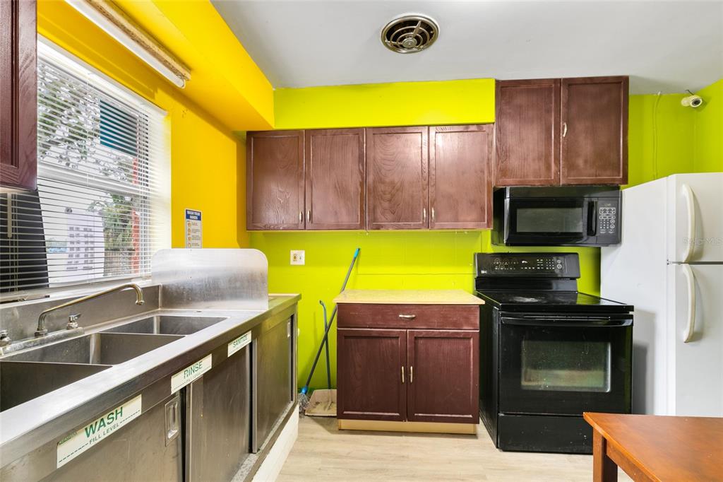 4607 North Pine Hills Road Orlando, FL 32808 - Photo 18 of 26 a kitchen with a sink and a microwave