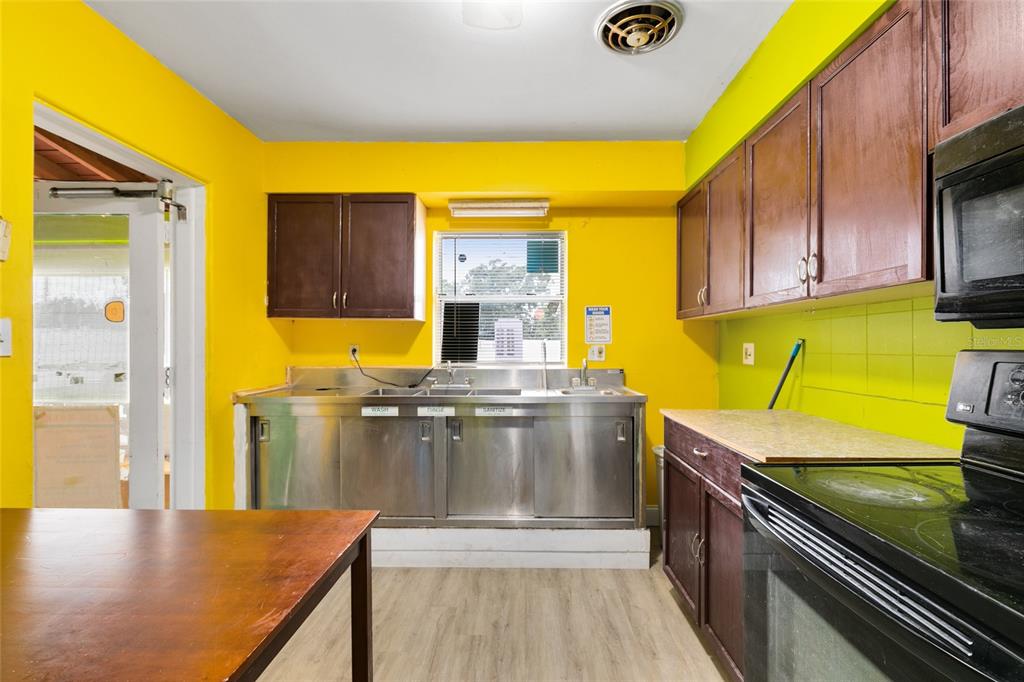 4607 North Pine Hills Road Orlando, FL 32808 - Photo 19 of 26 a kitchen that has a sink and a stove
