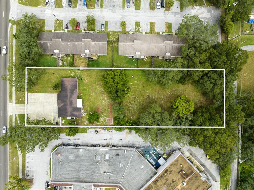 4607 North Pine Hills Road Orlando, FL 32808 - Photo 2 of 26 an aerial view of houses with a lake