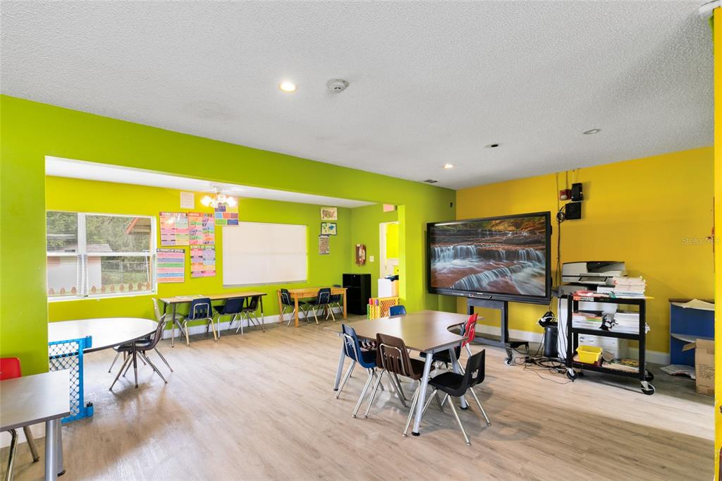 4607 North Pine Hills Road Orlando, FL 32808 - Photo 5 of 26 a living room with furniture and a floor to ceiling window