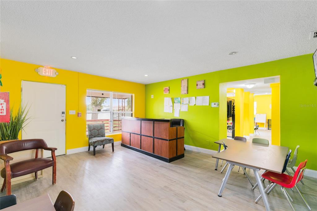 4607 North Pine Hills Road Orlando, FL 32808 - Photo 6 of 26 a living room with furniture and a table