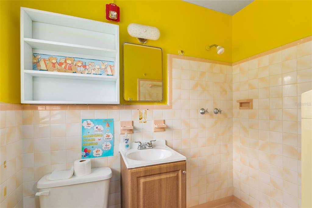 4607 North Pine Hills Road Orlando, FL 32808 - Photo 8 of 26 a bathroom with a sink mirror vanity and toilet