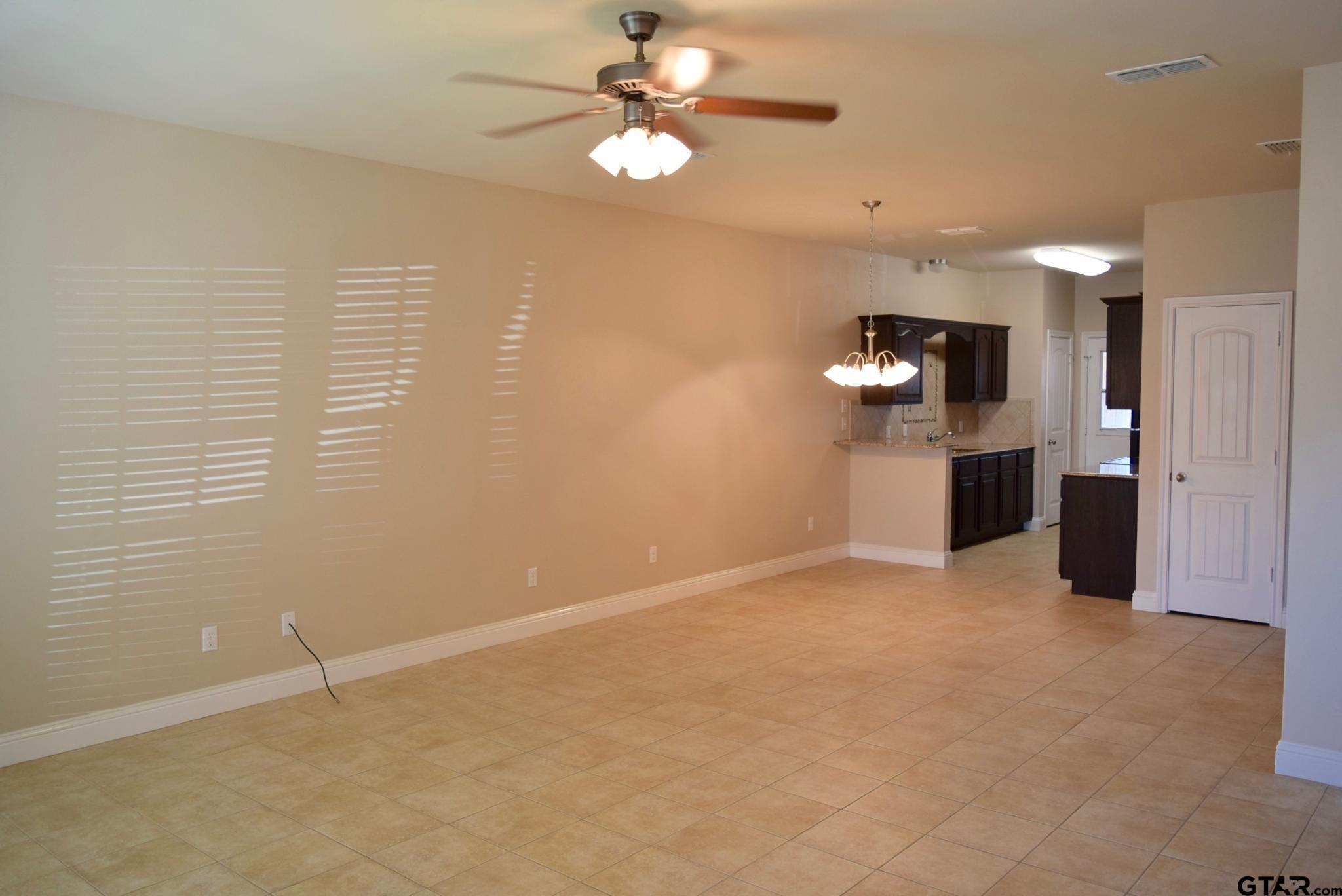 303-309 Princess Place Tyler, TX 75704 - Photo 2 of 6 wooden floor in an empty room with a window