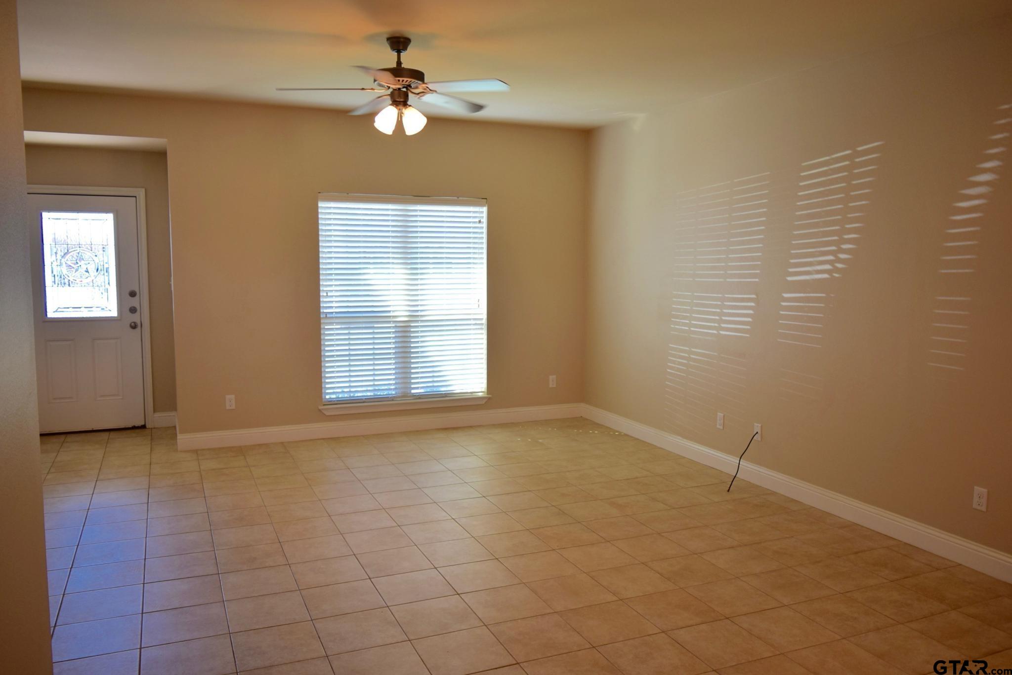 303-309 Princess Place Tyler, TX 75704 - Photo 6 of 6 an empty room with windows and fan