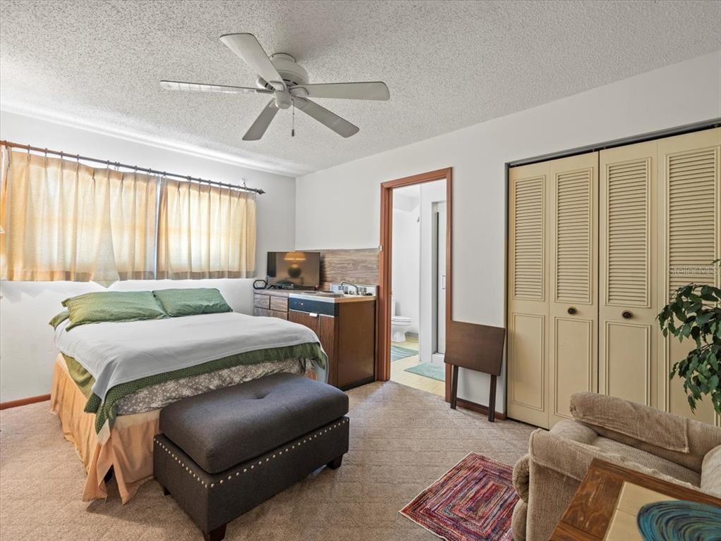 18218 Sunset Boulevard, Unit B St. Petersburg, FL 33708 - Photo 30 of 38 a bedroom with a bed and a couch