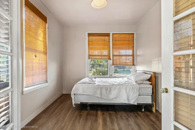 a bedroom with a bed and a mirror