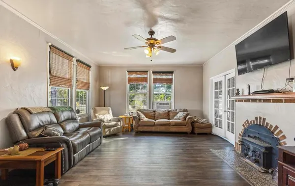 a living room with furniture a flat screen tv and a fireplace