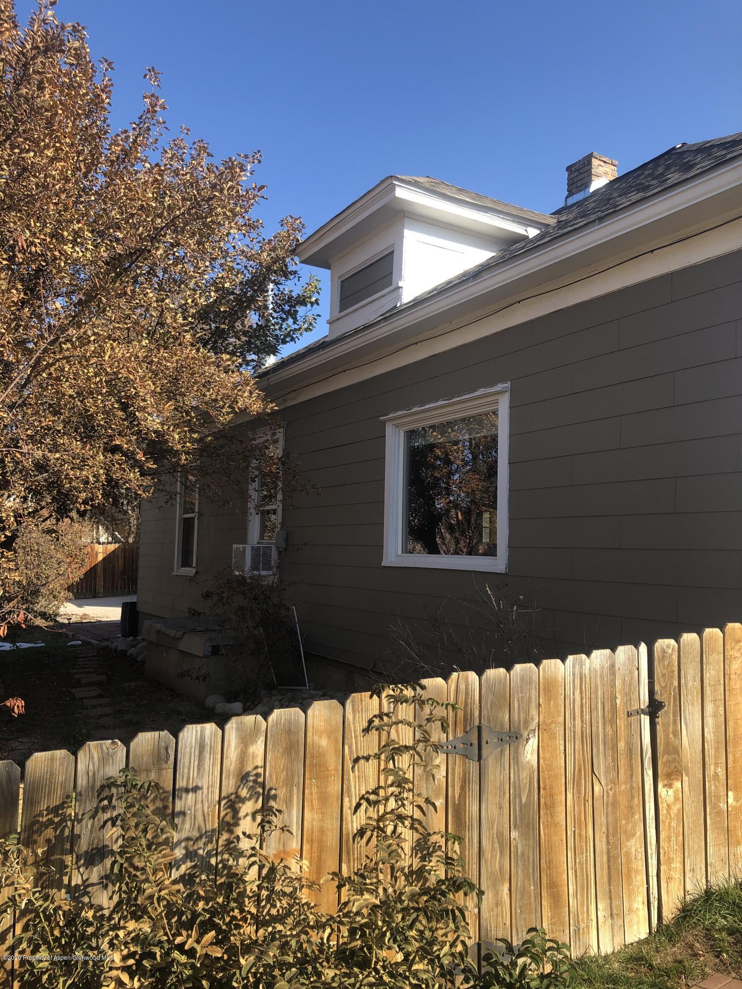310 East 5th Street Rifle, CO 81650 - Photo 1 of 27 a front view of a house with a yard
