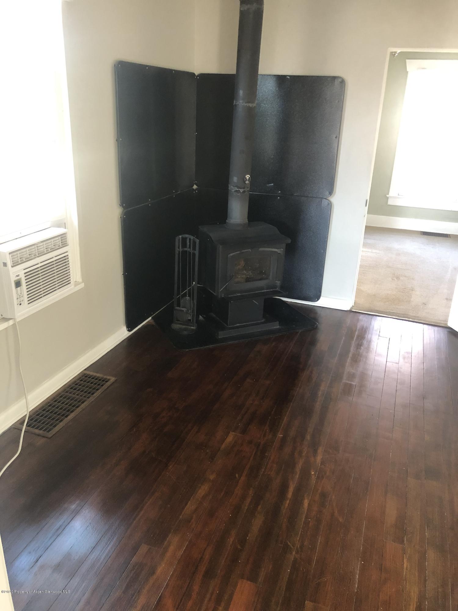 310 East 5th Street Rifle, CO 81650 - Photo 12 of 27 a view of an empty room with wooden floor and a window