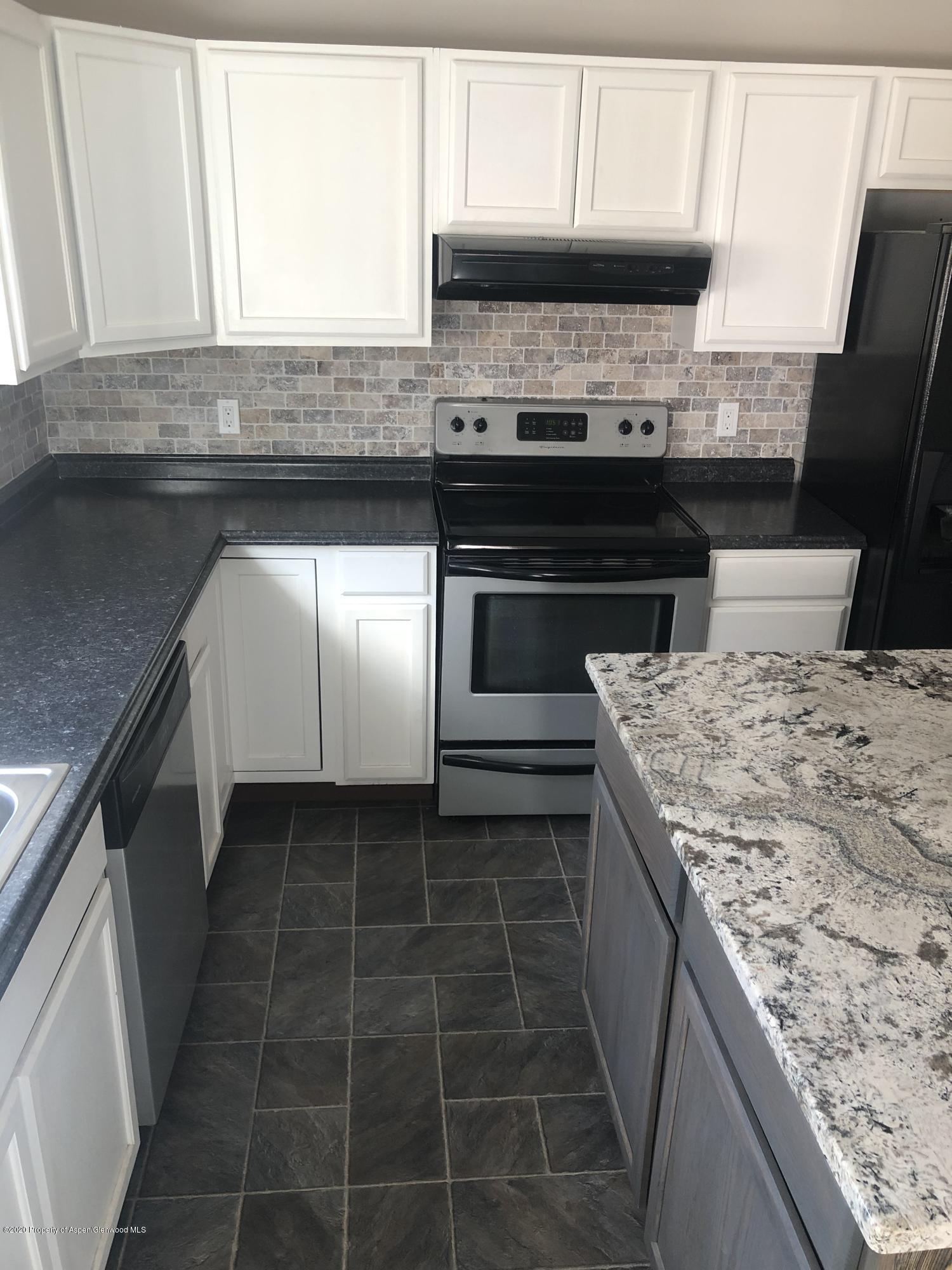 310 East 5th Street Rifle, CO 81650 - Photo 16 of 27 a kitchen with a stove and a microwave