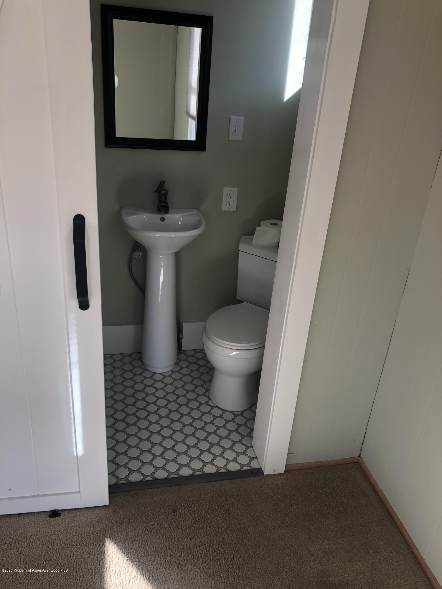 310 East 5th Street Rifle, CO 81650 - Photo 19 of 27 a bathroom with a sink toilet and a mirror