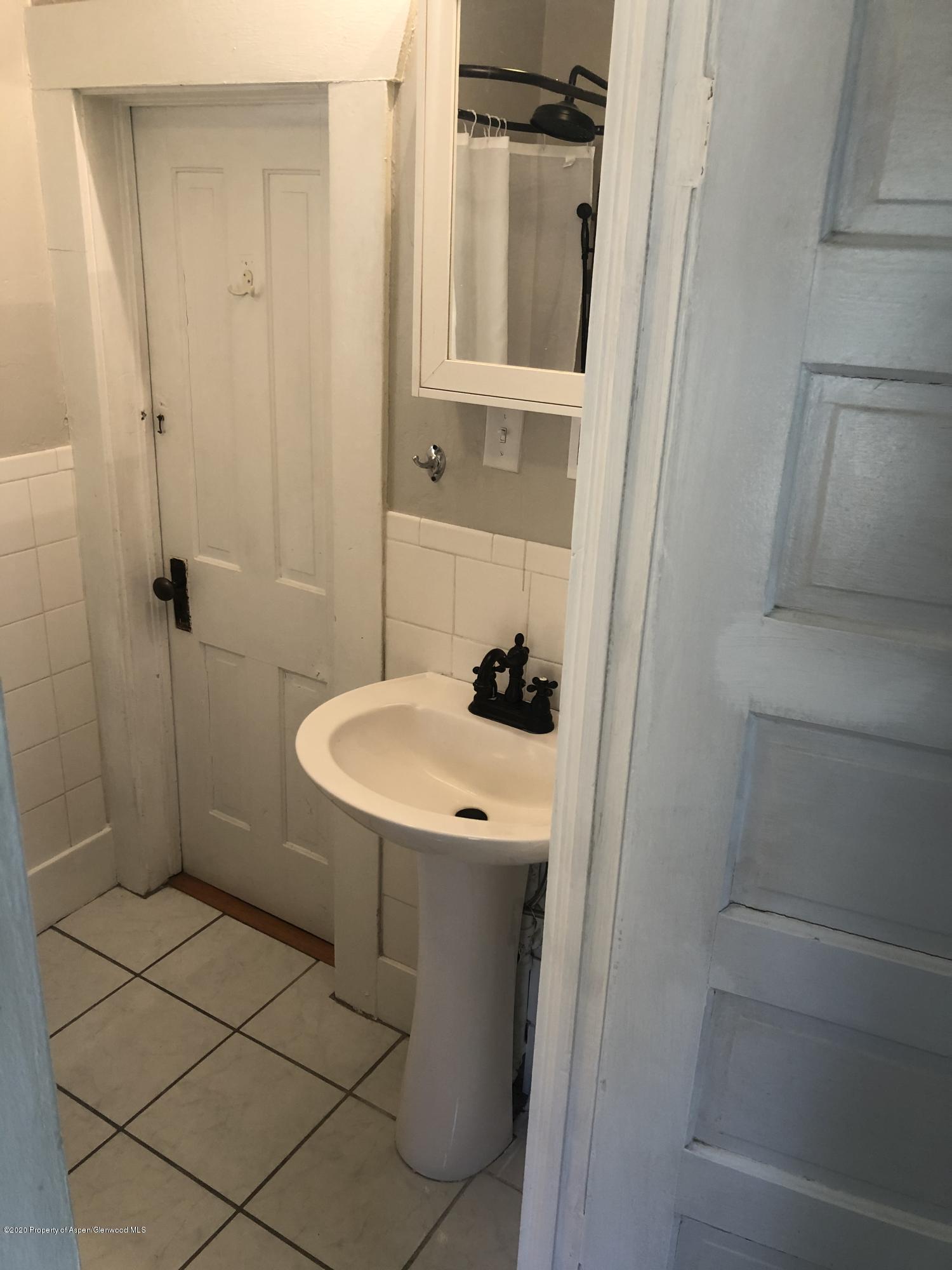 310 East 5th Street Rifle, CO 81650 - Photo 21 of 27 a bathroom with a sink a toilet and shower