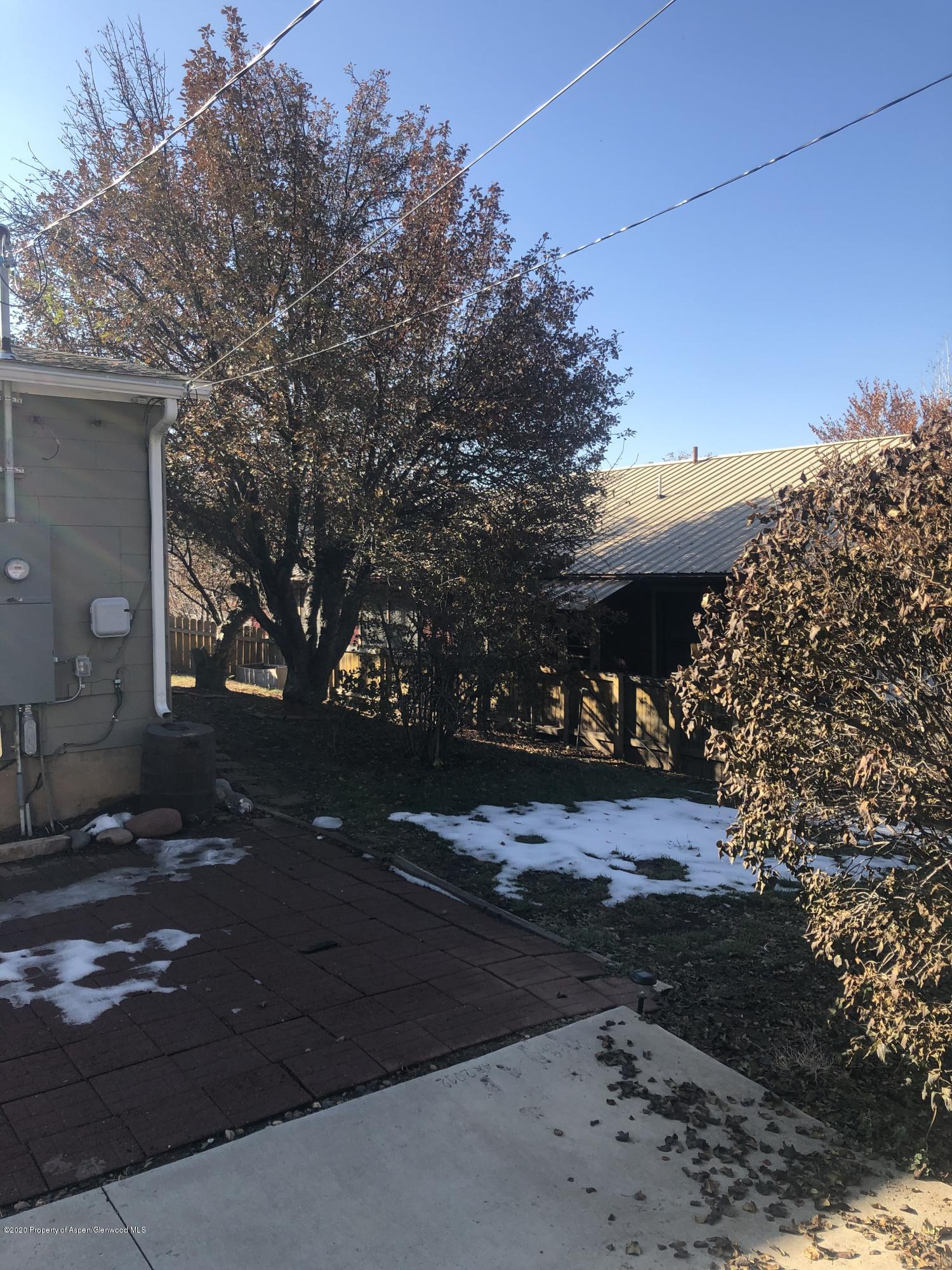 310 East 5th Street Rifle, CO 81650 - Photo 7 of 27 a front view of a house with a yard and garage