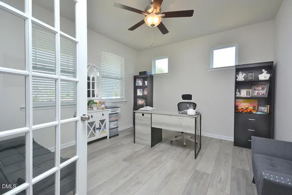 a kitchen with stainless steel appliances granite countertop a sink a stove a refrigerator cabinets and chairs