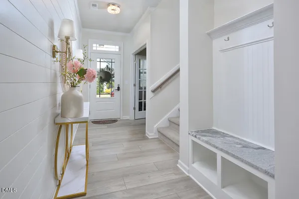a kitchen with stainless steel appliances granite countertop a sink a stove a refrigerator cabinets and chairs