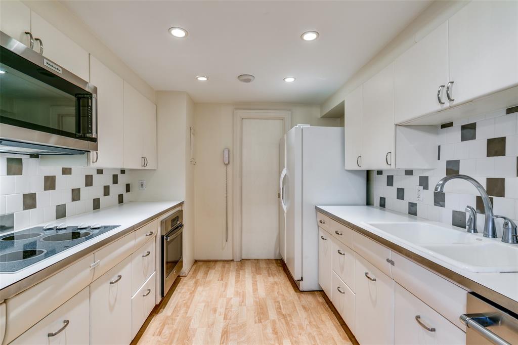3525 Turtle Creek Boulevard, Unit 3C Dallas, TX 75219 - Photo 14 of 28 Kitchen featuring backsplash, recessed lighting, stainless steel appliances, and a sink