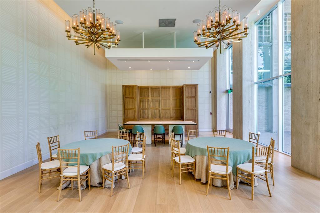 3525 Turtle Creek Boulevard, Unit 3C Dallas, TX 75219 - Photo 2 of 28 Dining space featuring a notable chandelier and wood finished floors