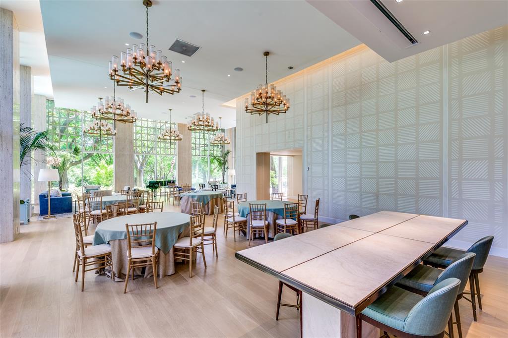 3525 Turtle Creek Boulevard, Unit 3C Dallas, TX 75219 - Photo 10 of 28 Dining room featuring a chandelier, light wood-style flooring, and a high ceiling