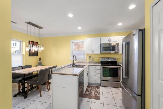 a kitchen with a sink appliances and cabinets