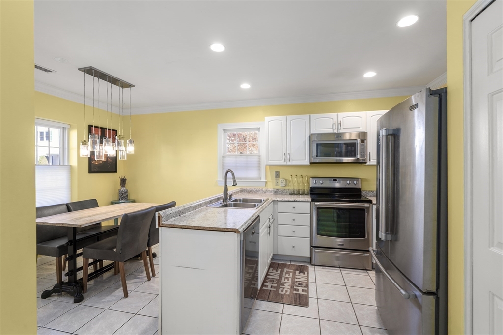 605 Middle Street, Unit 38 Braintree, MA 02184 - Photo 11 of 33 a kitchen with a sink appliances and cabinets